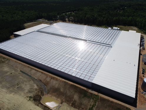 Aerial view of the Better Future Farms turnkey greenhouse built by Van der Hoeven in Australia, featuring large glass-covered structures for modern horticultural production.